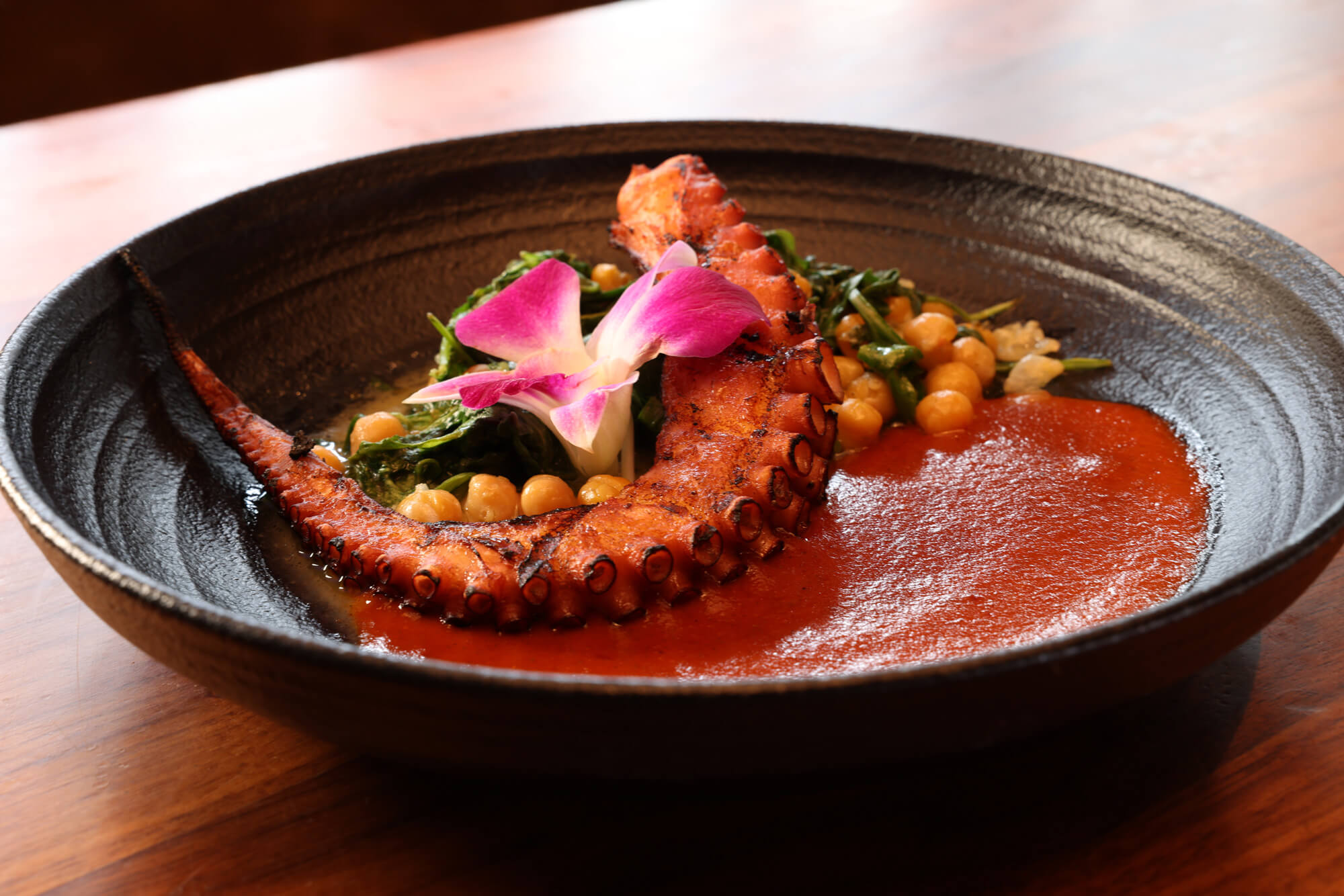 Char Grilled Octopus - Anchovy Caper Butter, Chickpea & Arugula Sauté, Harissa